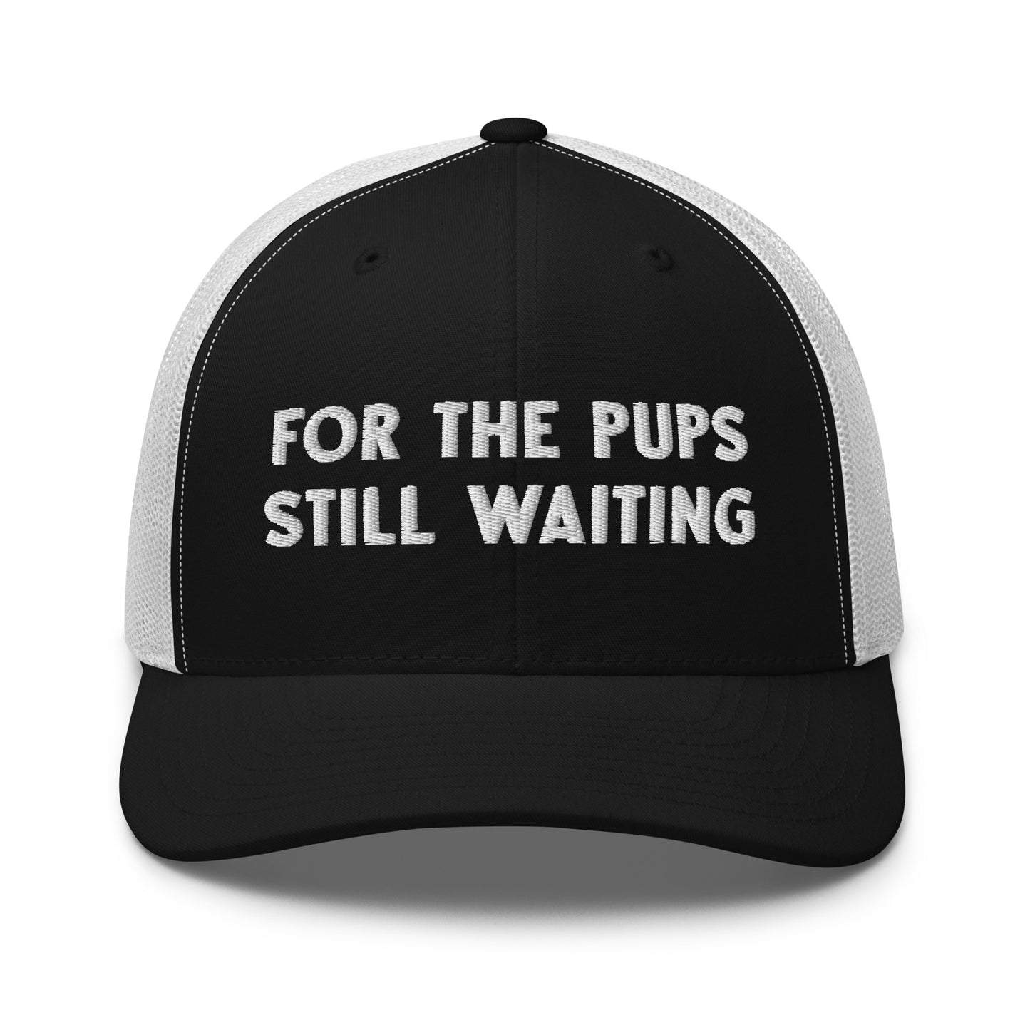 "For The Pups Still Waiting" trucker hat with embroidered text for dog moms, dog trainers, rescue volunteers, and pup people.